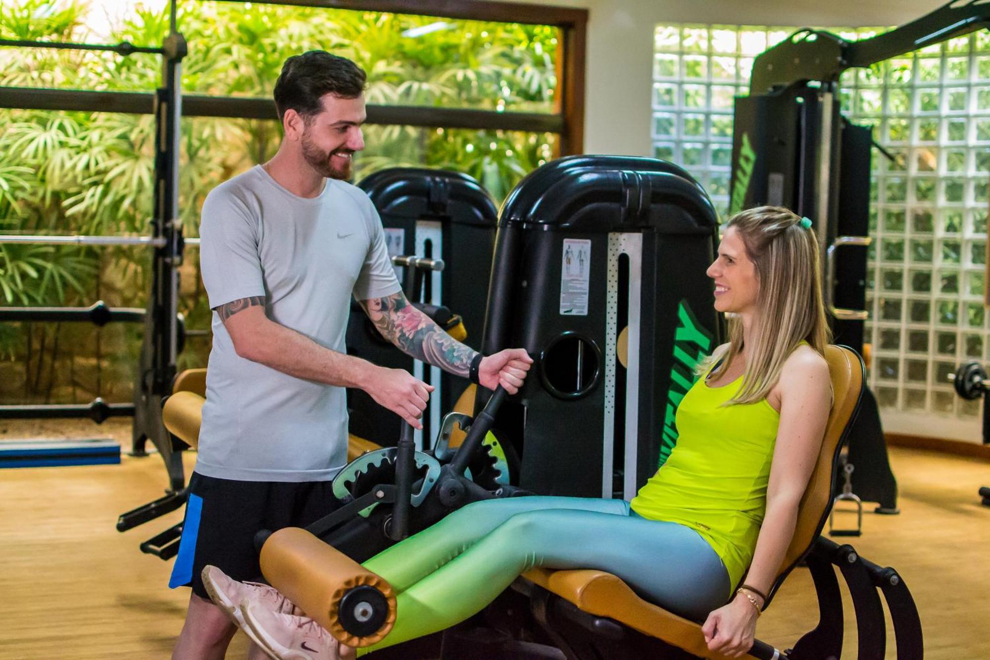Blue Tree Thermas De Lins Resort Exterior photo Personal trainer assisting a woman on a leg press machine